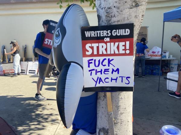 Photo of an orca whale next to a picket sign at the SAG strike