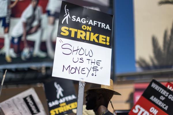 A photo including members of the Hollywood actors SAG-AFTRA unio<em></em>n walk a picket line with screenwriters outside of FOX Studios.