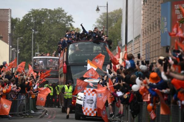 Luton Town football club players and staff parade through the streets of Luton with the Champio<em></em>nship playoff trophy in Luton, north of Lo<em></em>ndon on May 29, 2023, as they celebrate their promotion to the English Premier League. — AFP pic
